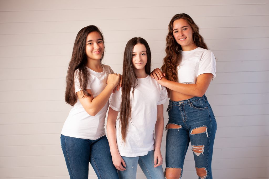 Teenagers wearing jeans and white t-shirts